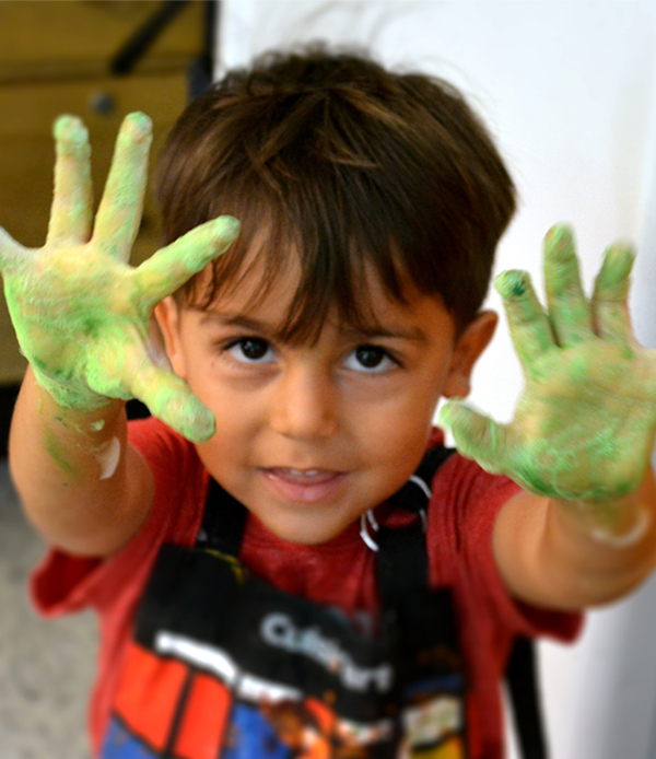boy with green hand paint