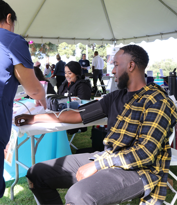 man getting vaccine at outdoor clinic