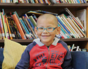 monarch school; boy in library