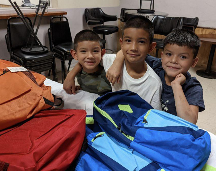 3 boys with new backpacks