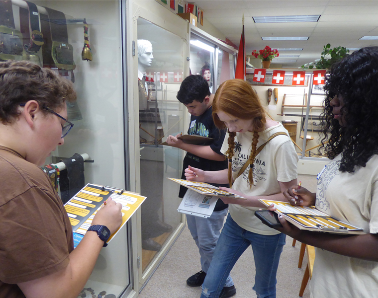 Students studying artifacts in museum