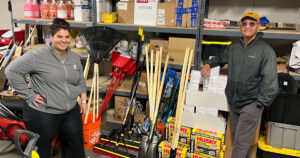 Anna Arancibia and Barry Pollard helping sort storm cleaning supplies at the YMCA