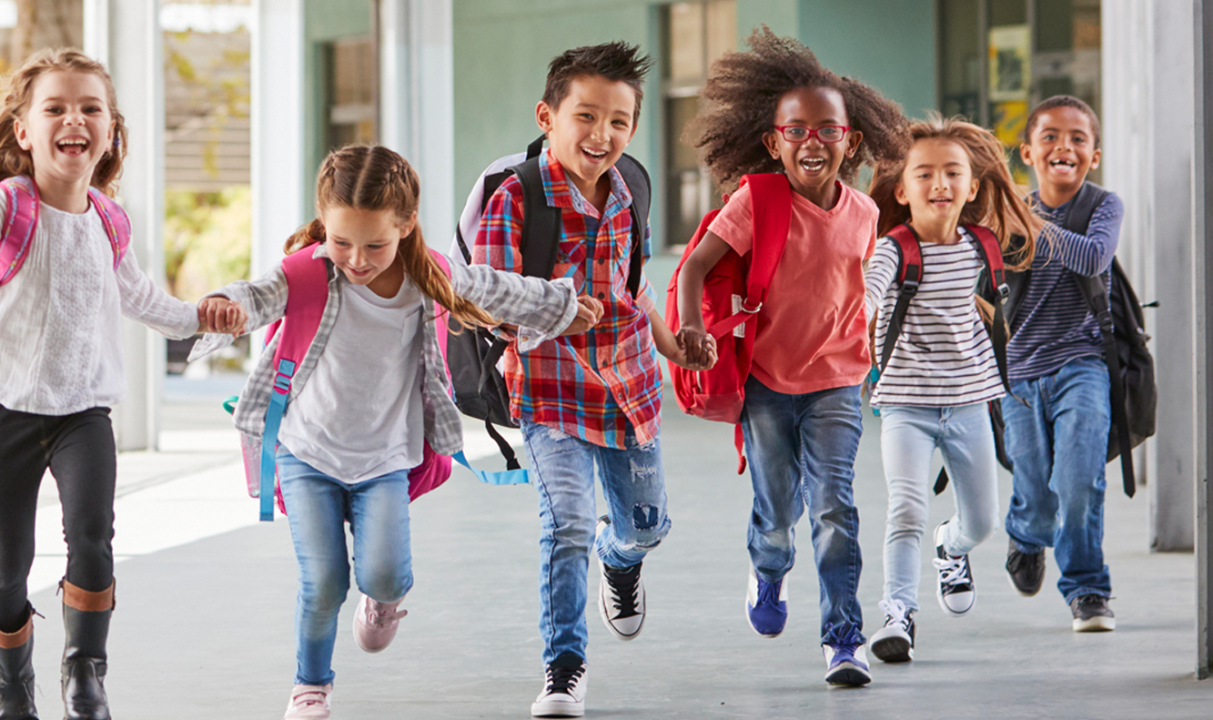 kids running in school corridor wearing backpacks